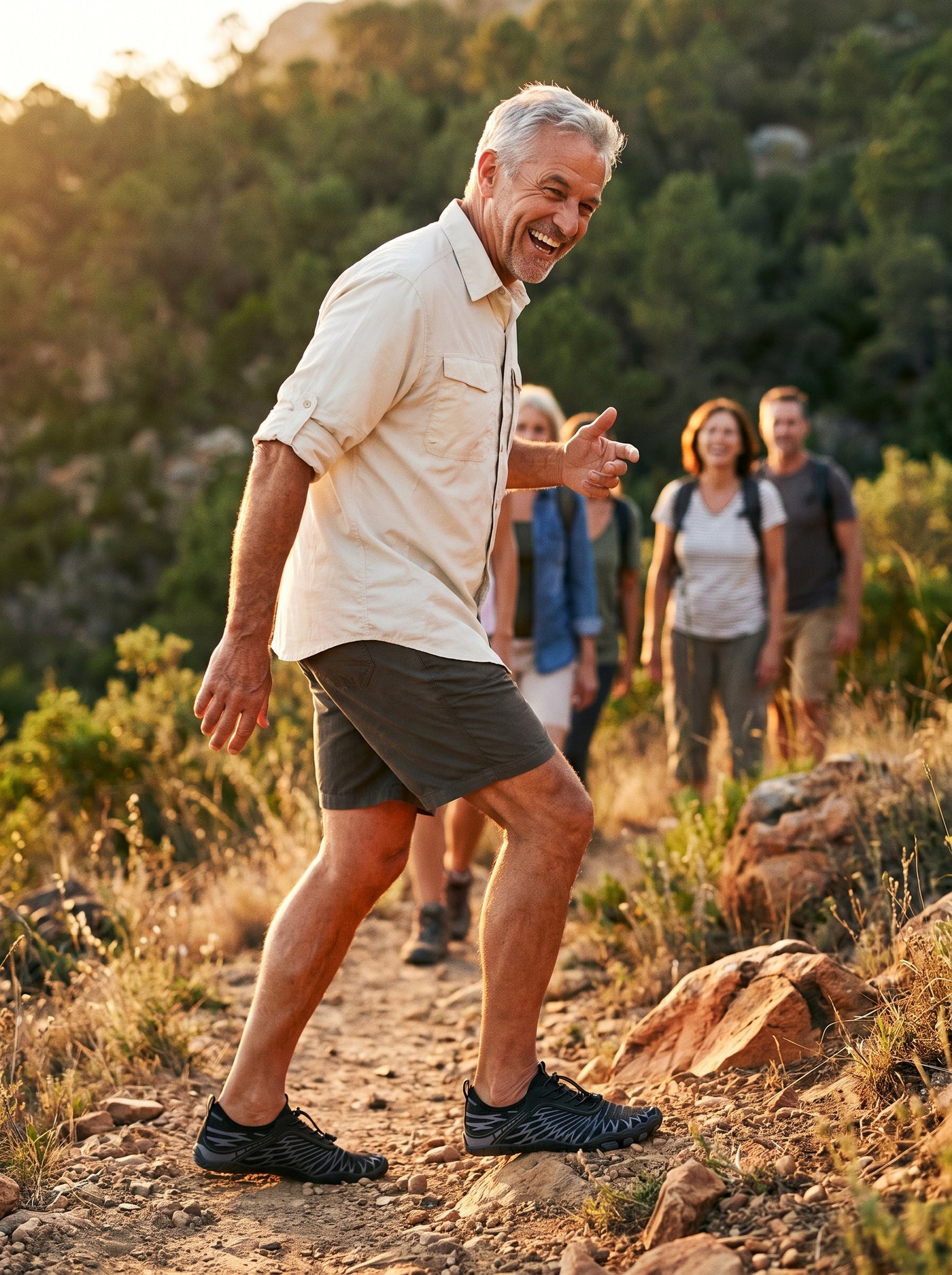 Man laughing on a hillside walk with friends