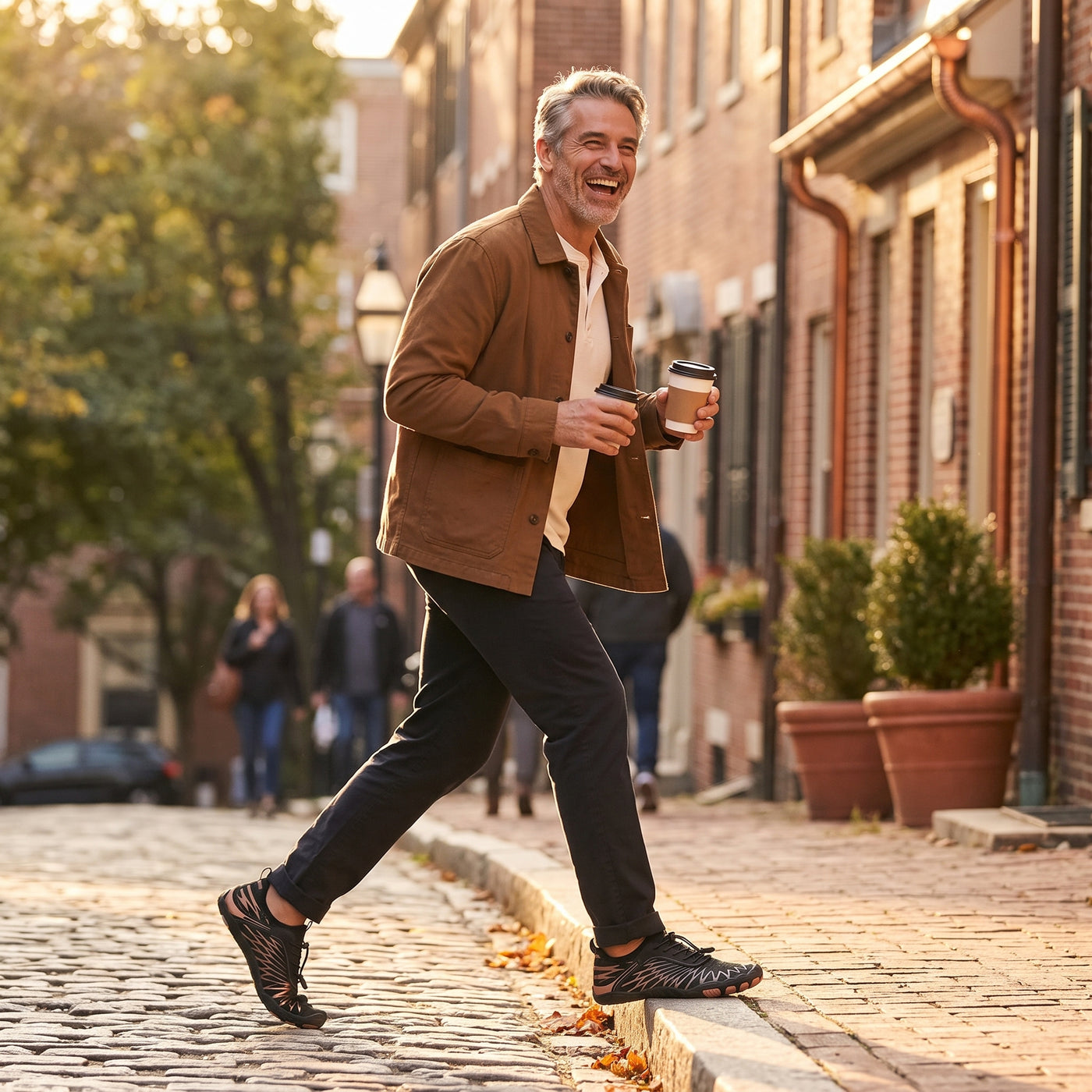 Man in his late fifties walking through town, coffee in hand